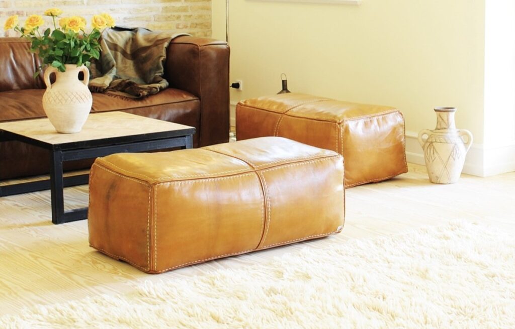Leather puffs in natural brown and coffee table in iron and handmade tiles - design and production by Villa