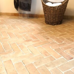 Authentic handmade unglazed Bejmat tiles in natural terracotta. Rustic tiles from Fez, Morocco – timeless warmth with unique artisan texture.