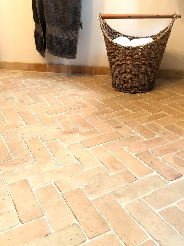 Authentic handmade unglazed Bejmat tiles in natural terracotta. Rustic tiles from Fez, Morocco – timeless warmth with unique artisan texture.