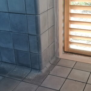 Discover handmade edge tiles in marble-cement — elegant curved tiles for seamless wall to wall transitions, crafted in Danish design.