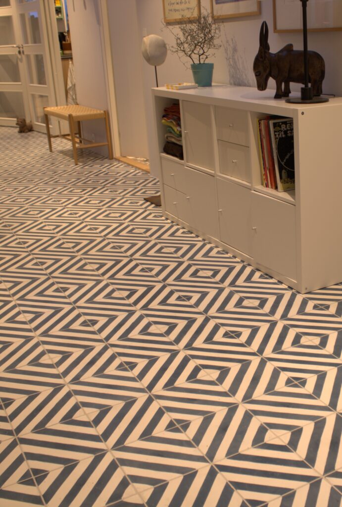This handmade encaustic cement tile in contemporay style brings timeless elegance to your interior. A refined geometric pattern in Nordic colors.