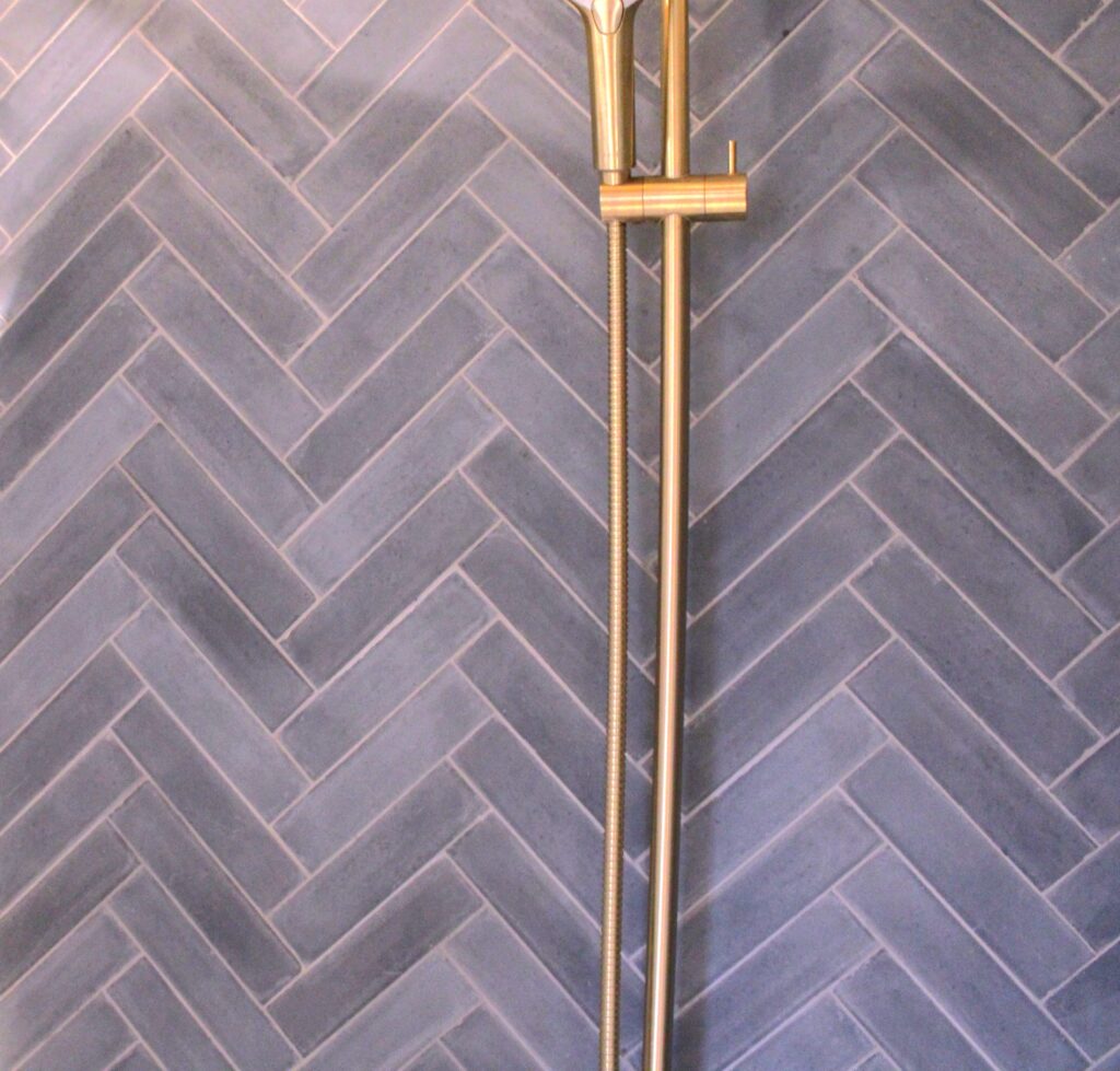 This handmade encaustic cement tile in contemporary style brings timeless elegance to your interior. A herringbone shape in Nordic colors.