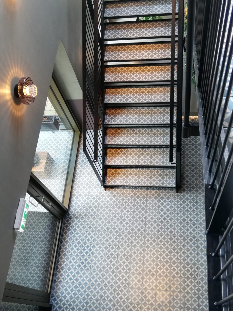 handmade encaustic cement tiles by Villa Tiles. Blue tiles in a descreet timeless pattern for restaurant stairs and floors.