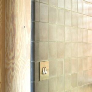 Discover handmade edge tiles in marble-cement — elegant curved tiles for seamless wall to wall transitions, crafted in Danish design.