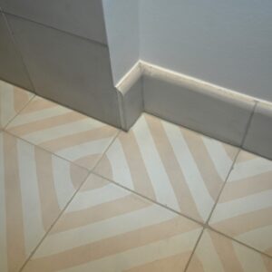 Discover handmade curved skirting tiles in marble-cement — elegant curved tiles for seamless floor to wall transitions, crafted in Danish design.